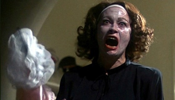 Image of Faye Dunaway portraying actress Joan Crawford in the infamous wire hanger scene from Mommie Dearest