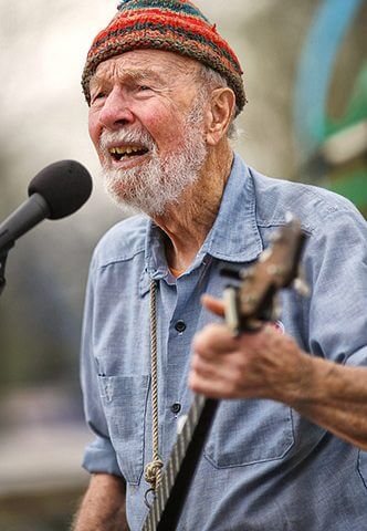 Pete Seeger playing a banjo and singing