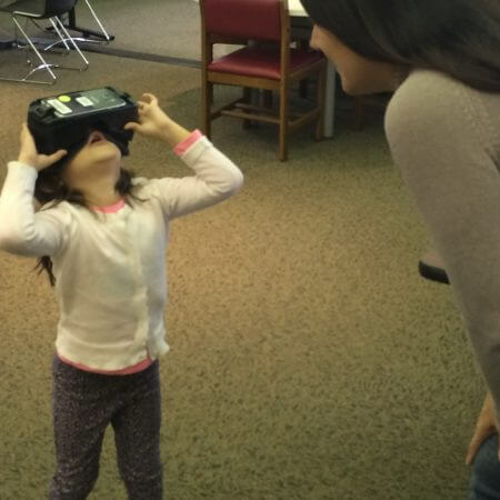 A mother and daughter exploring virtual reality at a VR Walk-In Open Play.