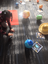 Girl explores solar system. 