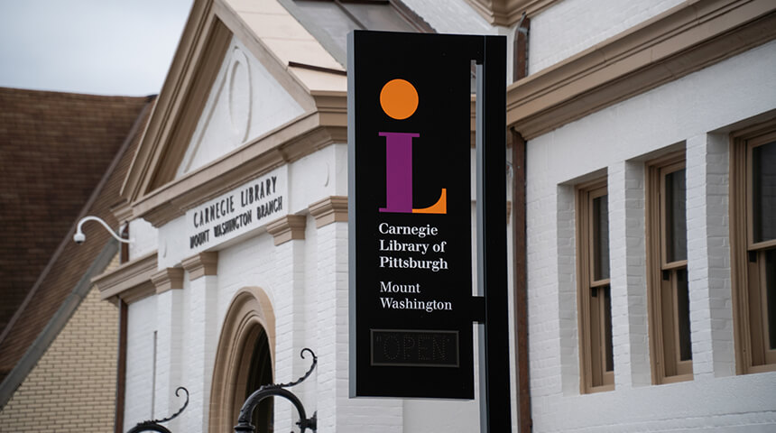 Exterior of CLP - Mount Washingon with focus on the Library Open sign.