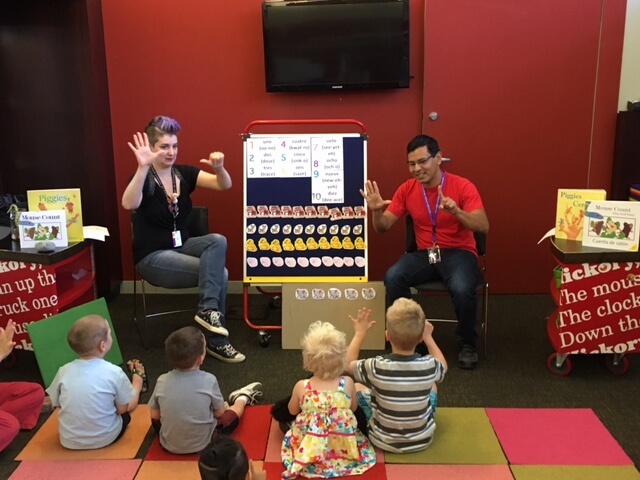Two librarians count with children in storytime