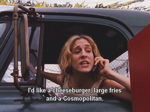 Carrie Bradshaw, character of Sex in the City, orders a cheeseburger, large fries, and a Cosmopolitan at a drive thru