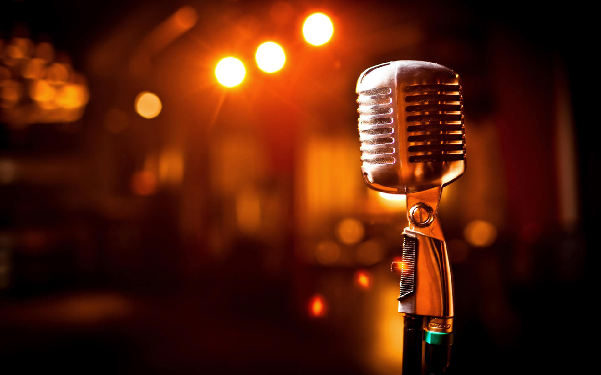 Retro microphone on stage with blurred lights in the background