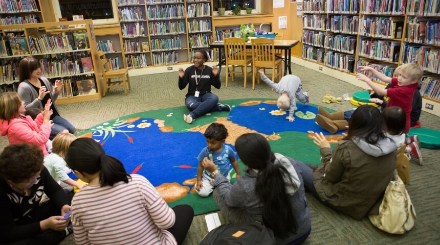 Librarian leads children and caregivers in storytime