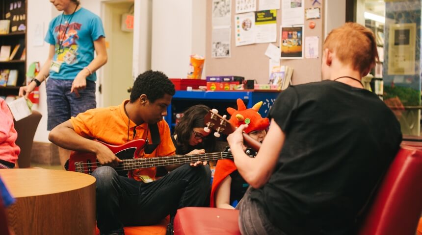 Teens playing guitar during Teen Time
