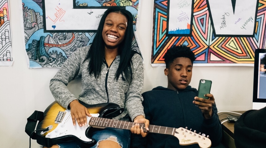 Teens playing guitar during Teen Time