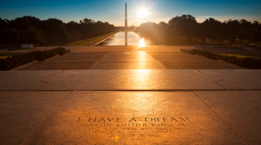 Martin Luther King "I have a dream" quote on the steps of the Lincoln Memorial on The National Mall in Washington, D.C. at sunset.