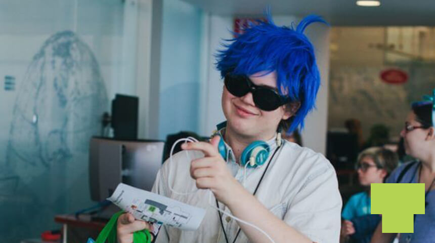 Teen wearing a blue wig, sunglasses, and headphones.
