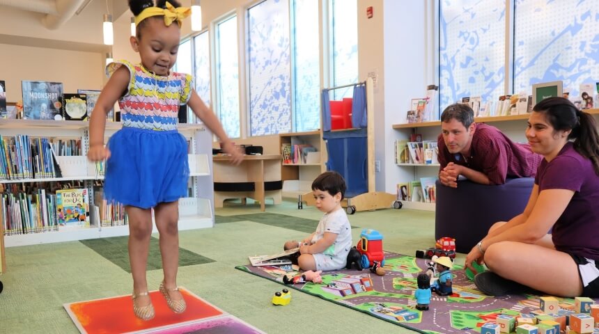 Children and parents playing in the children's room at CLP-East Liberty.