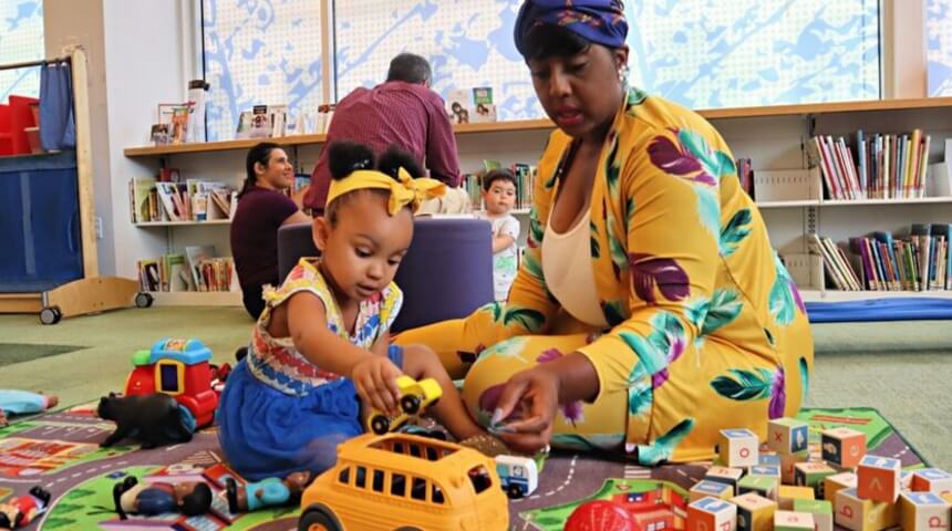 Parent with child playing in children's room at CLP-East Liberty.