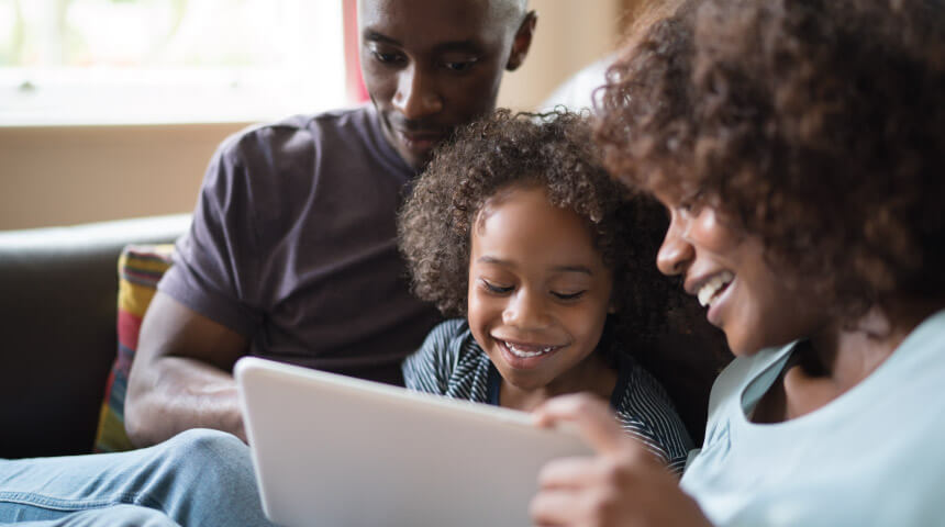 Family looking at a tablet together.