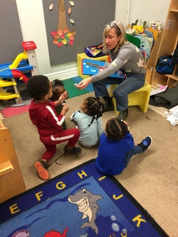 A library assistant uses a feltboard during a classroom storytime 