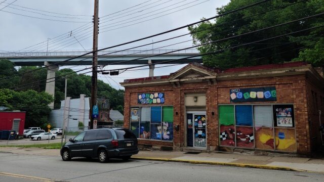 Exterior photo of the original CLP-Woods Run building, now a daycare center with bright decorations in windows