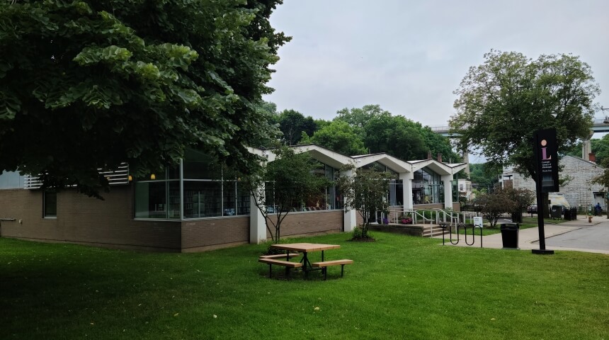 Exterior photo of CLP - Woods Run with picnic table, green grass and trees
