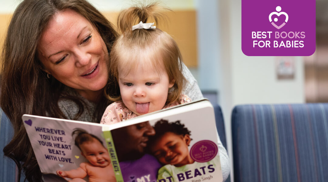 Mother reading a board book to a baby girl