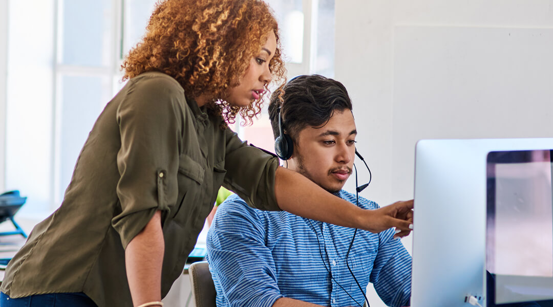 Person providing assistance at computer