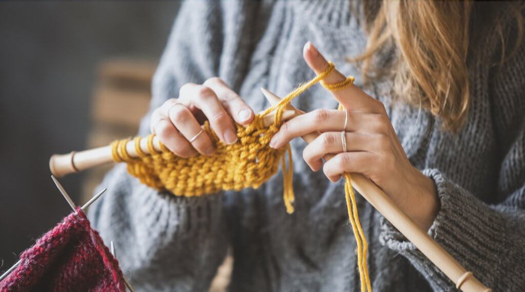 Close up on woman's hands knitting