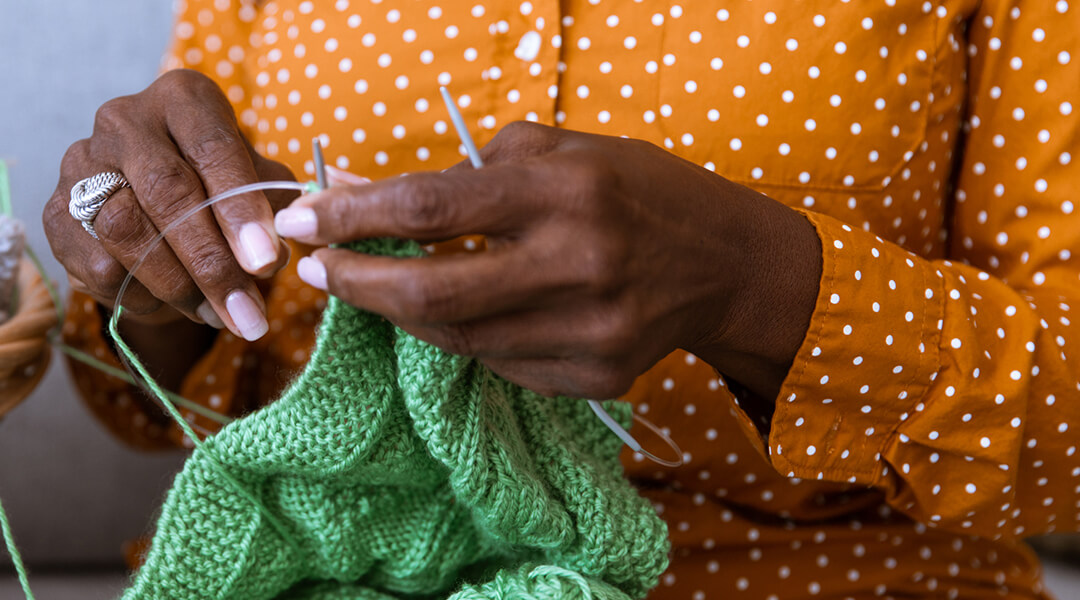 Close up on hands knitting