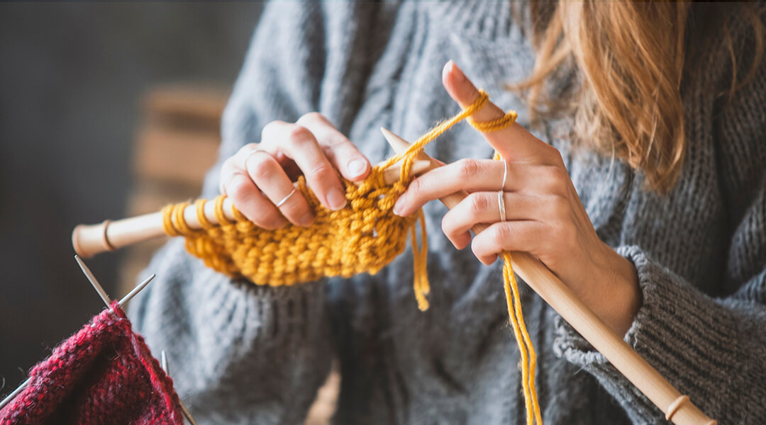 Close up on woman's hands knitting