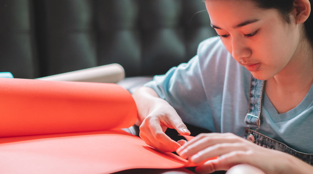 Teenager focused on a paper craft