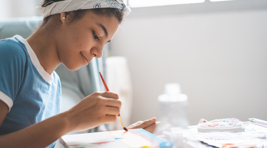 Teen painting on canvas