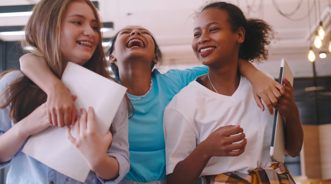 Three teens walking and laughing