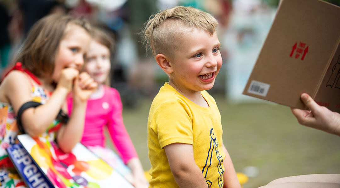 Close up of a toddler sitting front-row for storytime