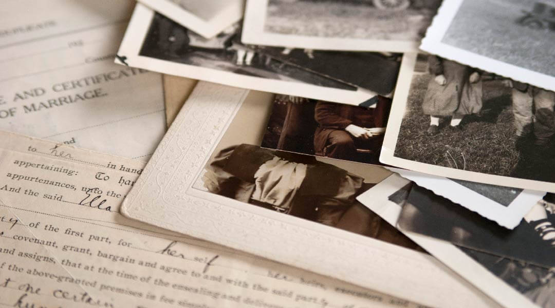 Old family photos and other documents on a table.