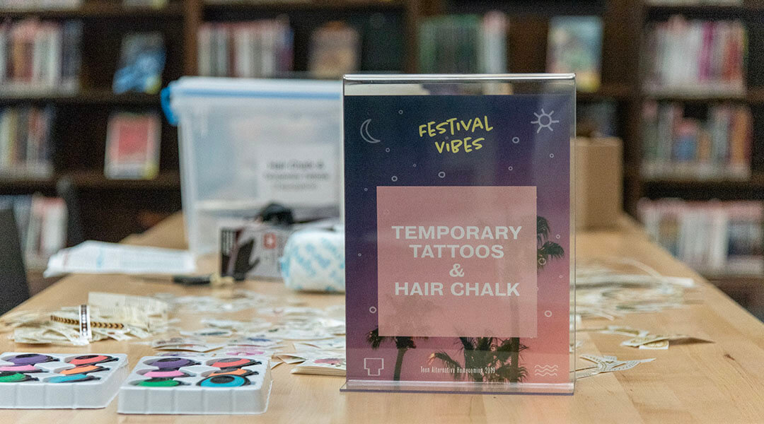 Table display in the Teenspace featuring temporary tattoos and hair chalk