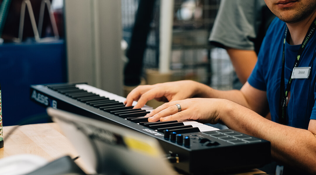 A person plays electronic keyboard.
