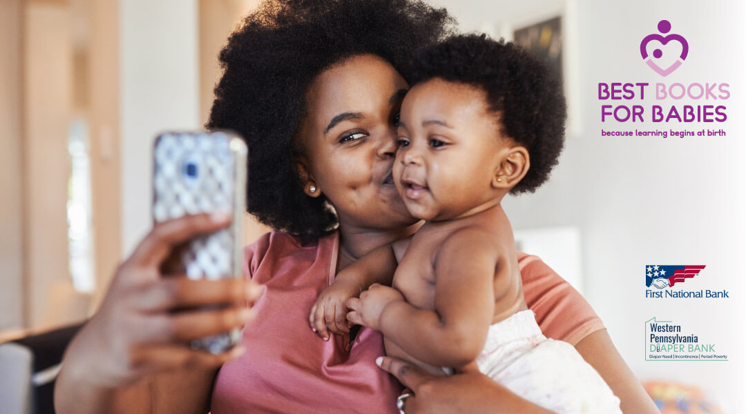 A parent takes a selfie with a smiling baby.