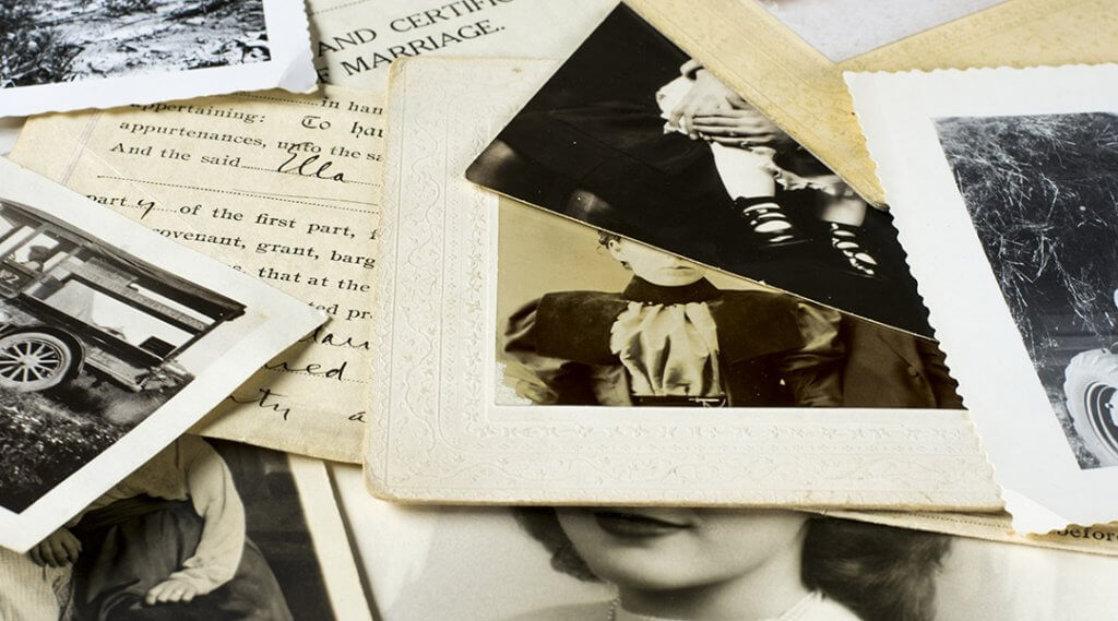 Genealogy family history theme with old family photos and documents.