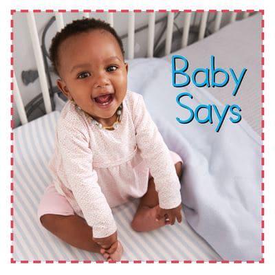 "Baby Says" book cover featuring a smiling baby sitting in a crib