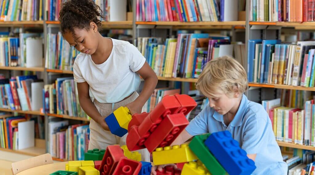 Children play with large building blocks in the library.