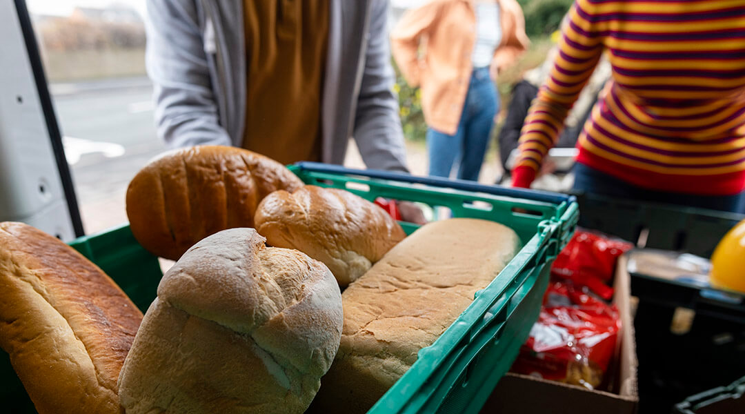 Close up of loaves of bread in a van being delivered to a food bank.