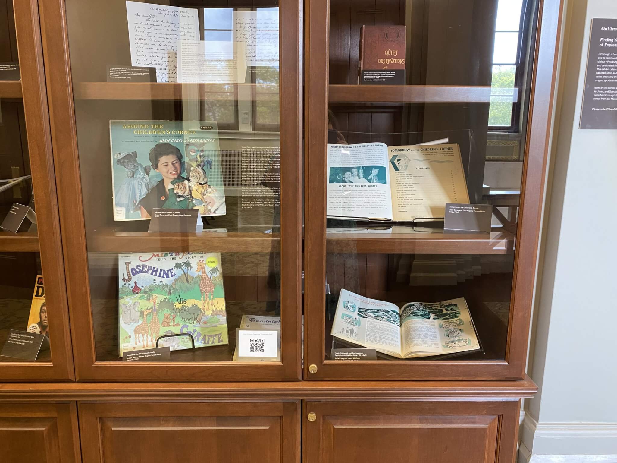 Glass and wood exhibit case with records and other exhibit materials