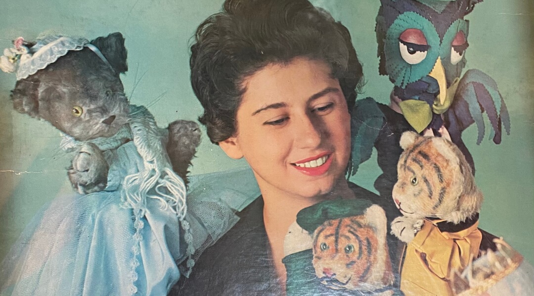 Young woman, Josie Carey, surrounded by puppets