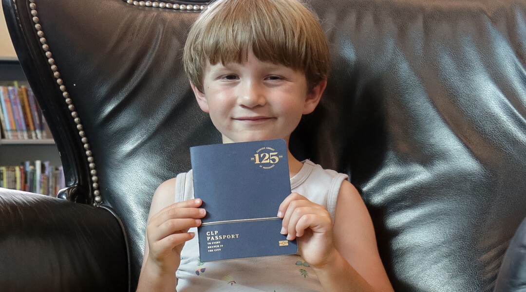 Five-year-old Ben Wilson proudly holds up his completed CLP Passport.