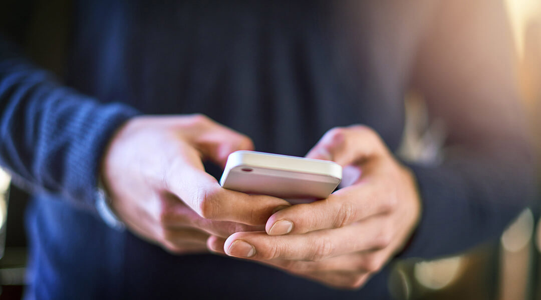 Closeup shot of an unrecognizable person using a cellphone.