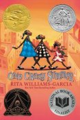 Cover for book One Crazy Summer. Illustration of three African American children in colorful dresses walking in a row.