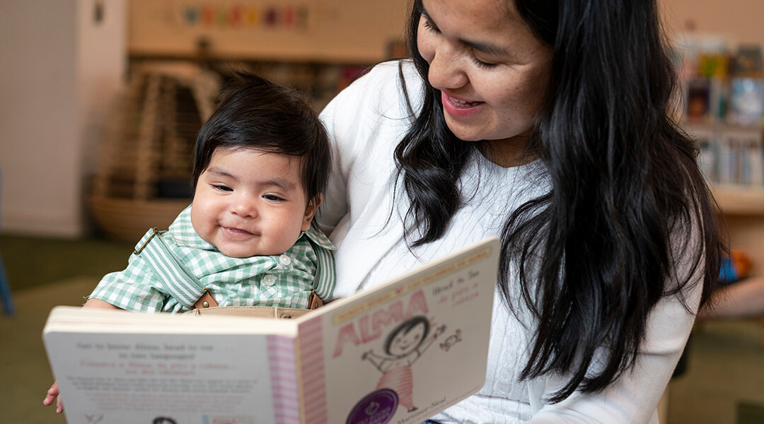 Mom and happy baby reading a Best Books for Babies board book